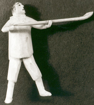 Sculpture of a standing man holding an ice-scoop