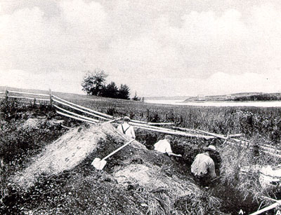 Three men doing an archaeological dug out.