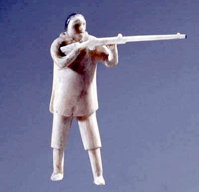 Sculpture of a hunter wielding a gun.