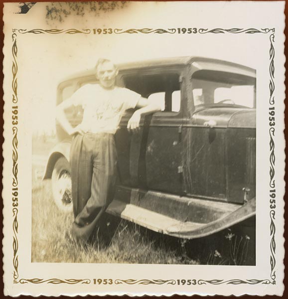 Chris Bennedsen with his first car, a 1931 Oldsmobile, Cobourg, Ontario, 1953