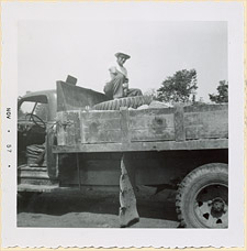 Clifford Jenkins, owner of Jenkins Cartage, picking up flagstones in Huntsville, Ontario, 1954.