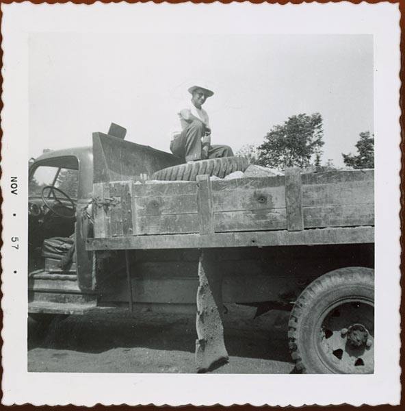 Clifford Jenkins, owner of Jenkins Cartage, picking up flagstones in Huntsville, Ontario, 1954