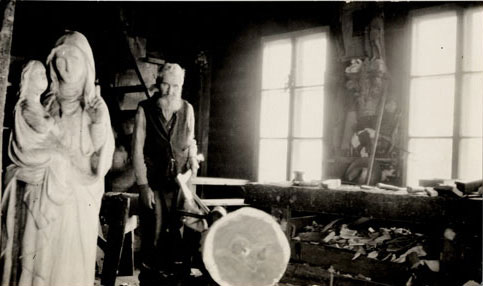 The Sculptor Louis Jobin in his studio, next to a statue of the Virgin and infant Jesus., © CMC/MCC