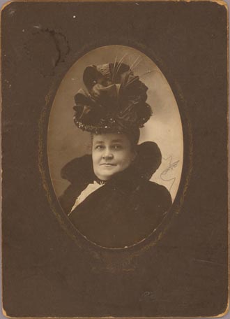 Photograph of a woman wearing an elaborate hat