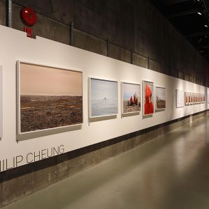 A long gallery space with framed pictures on the walls