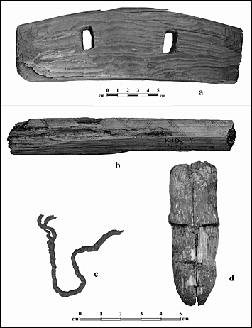 A flat plank and a piece of a wooden artifact