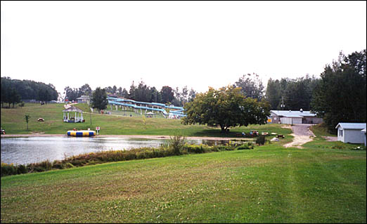 View of a resort and waterslides with a lake in foreground.