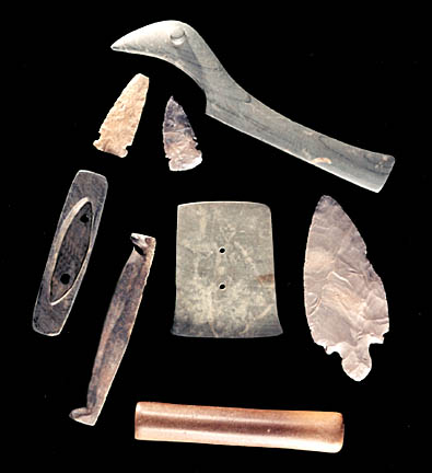 Polished stone artifacts: bird stone, boat stone, barstones and gorget.