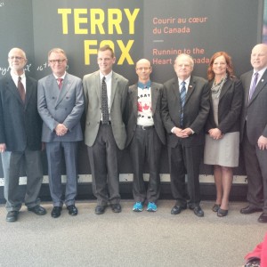 Terry’s friends and family pose with Museum President and the exhibition curator in the exhibition Terry Fox – Running to the Heart of Canada.