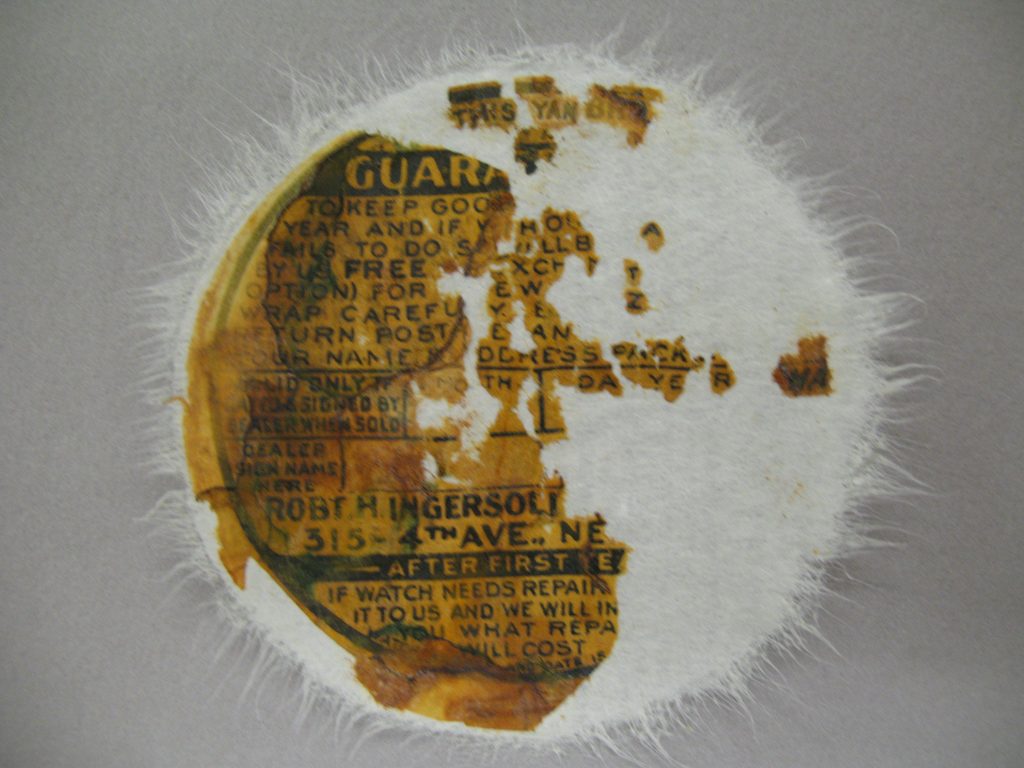 During treatment, all of the recovered fragments, most of which were retrieved from the cavity of the watch, were adhered, one by one, to Japanese paper (white in this image). Japanese paper is frequently used for this kind of work, because it is strong but will not damage fragile paper fragments.