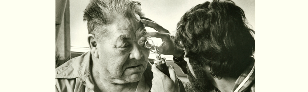 Nurse examining the eye of Haida Elder