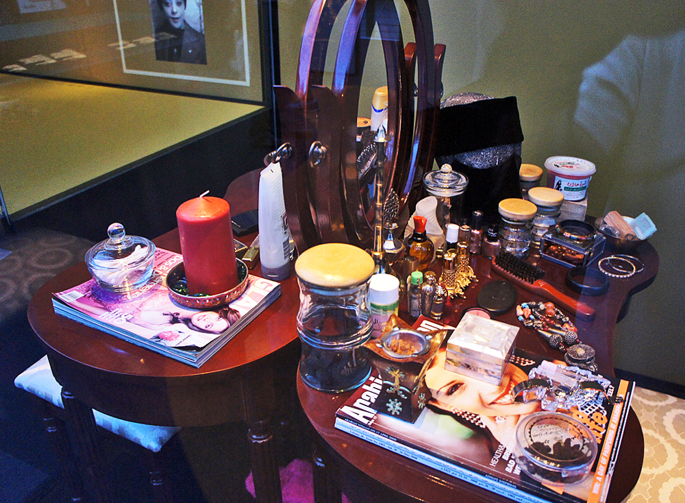 Photo of Mirror, Mirror modern art installation by artist Laila Binbrek featured in the Canadian History Hall. It is composed of two dressing tables covered with various items that reflect how the many elements of her identity, including her faith, intersect.