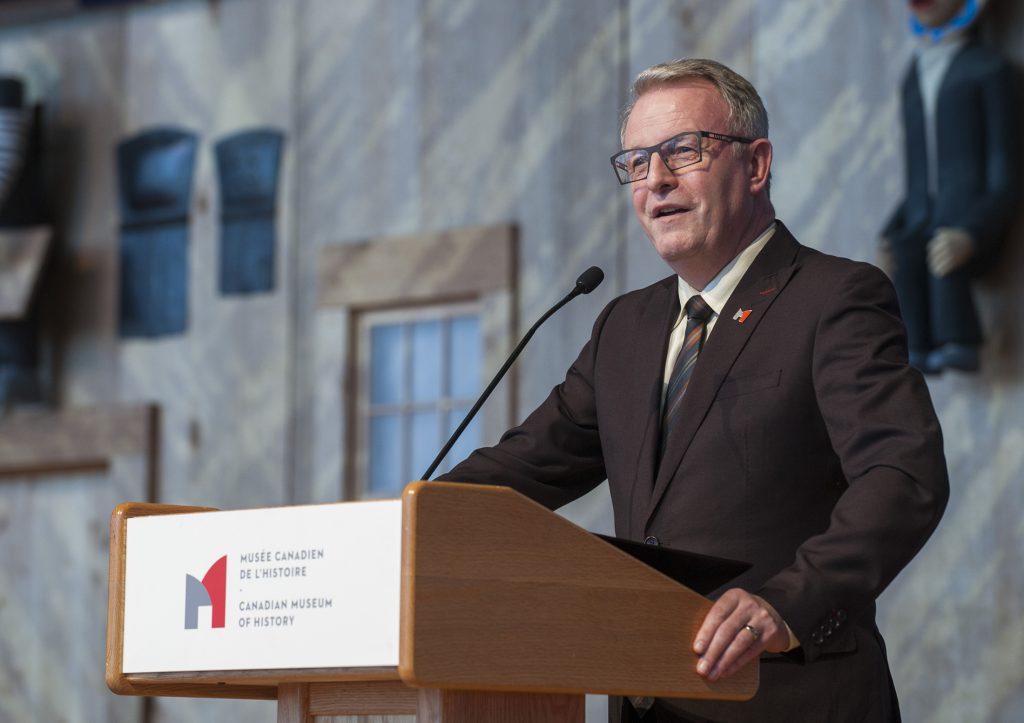 Mark O’Neill at a podium