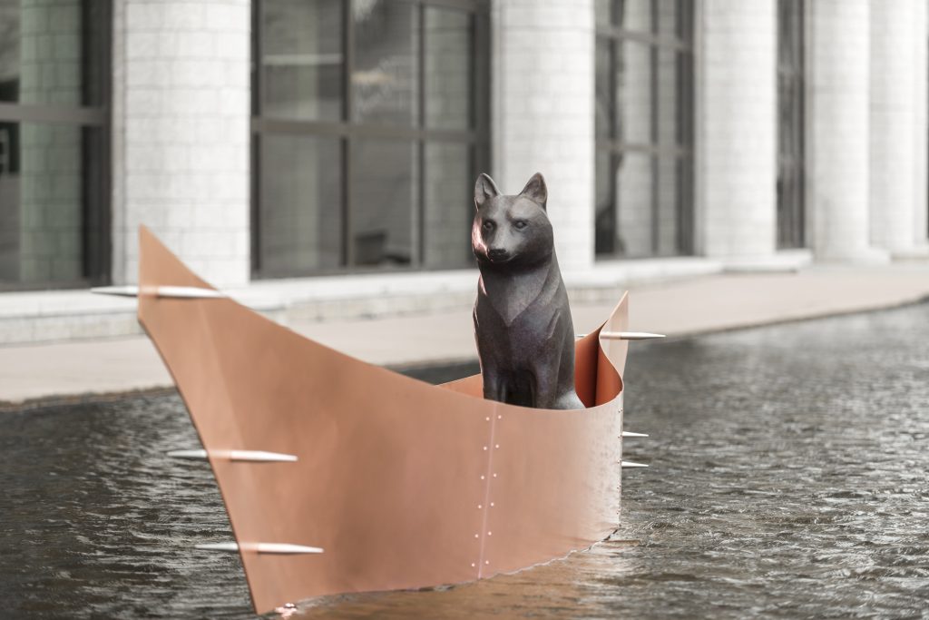 Life size sculpture of a wolf in a canoe