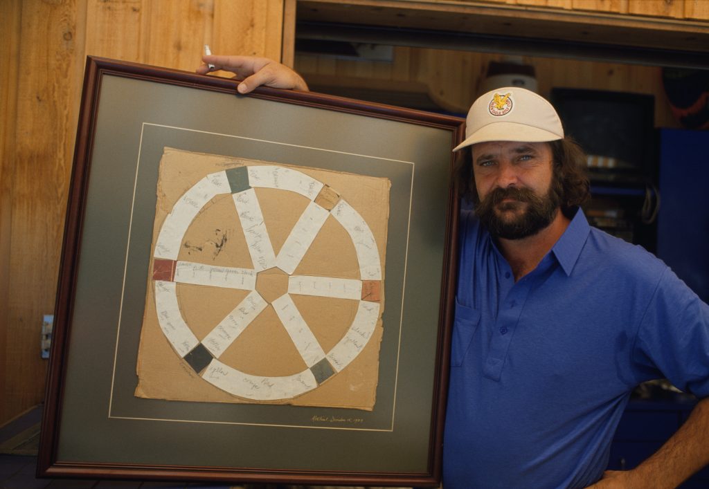 Trivial Pursuit co-creator Chris Haney holds a copy of the original sketch for the game.