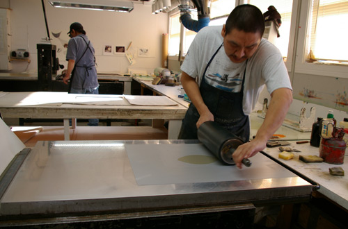 Printmaker Niviaqsi Quvianaqtuliaq creating a lithograph proof for, “Halibut,” by Ningeokuluk Teevee Printmaker Niviaqsi Quvianaqtuliaq creating a lithograph proof for, “Halibut,” by Ningeokuluk Teevee