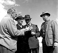 Jules Timmins examines an iron ore sample, Ungava, 1940s-1950s