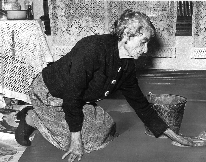 Old Age Pensioner scrubbing floors to supplement her pension, c. 1947 - NAC, detail of PA93924