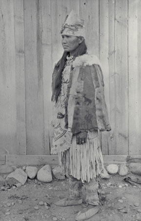 Christine TsEkEnêlxEmux, a Nlaka'pamux (Thompson) woman, wearing traditional clothing; it consists of a type of dress usually worn by older women, on occasion also worn by young girls, beaded moccasins, fringed, painted leggings, and a fringed skirt, all made of buckskin., © CMC/MCC, J.A. Teit, 23211
