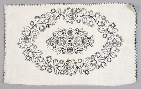 Typically Hungarian, a black and white embroidered floral motif adorns this homespun cushion cover., © CMC/MCC, 77-211