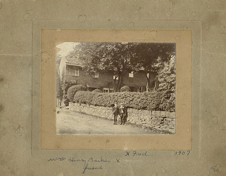 Photograph of two boys standing in front of a stone wall, dated 1907, © CMC/MCC, Magnus, Einarsson, MU-Vm-88-863