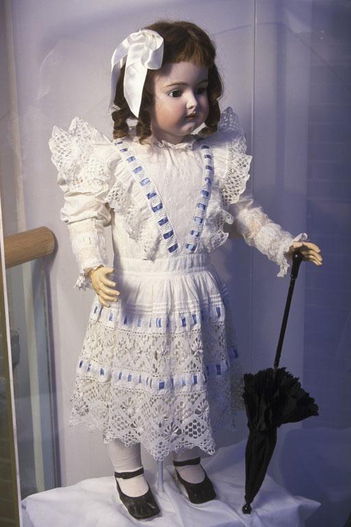 Bisque doll dressed in handmade clothes, 1890-1900