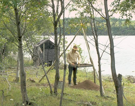 A man looking through the Tracadie prehistoric site.