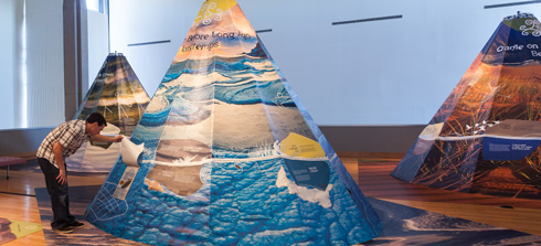 A man looking into a tepee