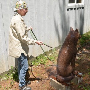 The process of creating the patina for the bronze wolf sculpture at the artist’s studio