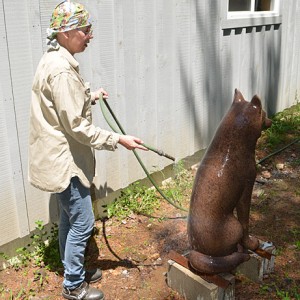 The process of creating the patina for the bronze wolf sculpture at the artist’s studio