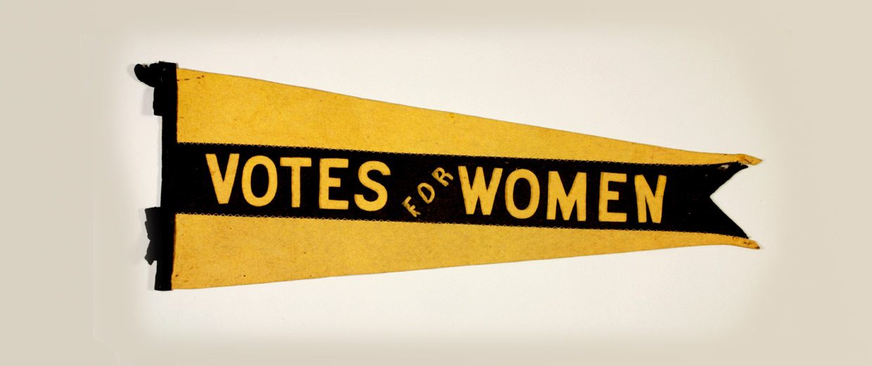 A yellow and black pennant with the words votes for women displayed in the Canadian Museum of History, in Ottawa.