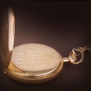 A gold pocket watch with a quote on it, displayed at the Canadian Museum of History in Ottawa.