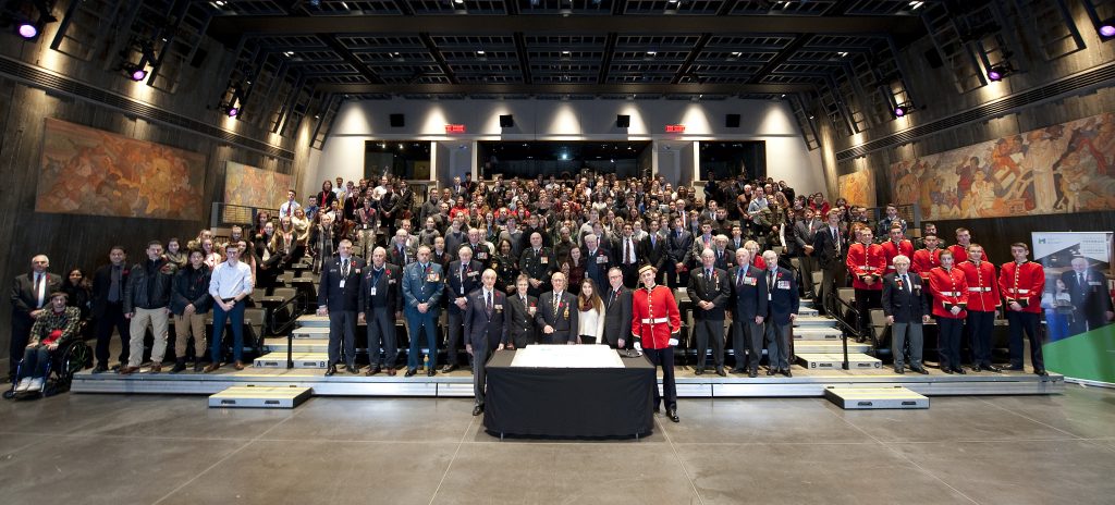 A large group of Canadian veterans in the Canadian War Museum.