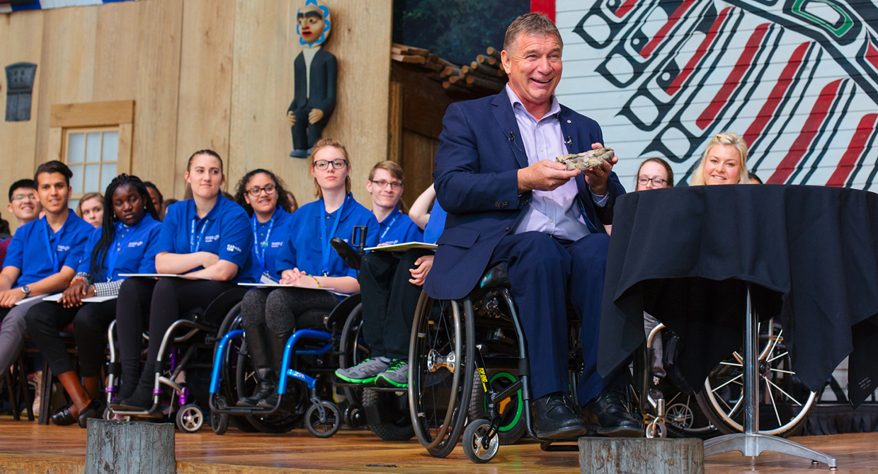Rick Hansen with a glove from the Man in Motion World Tour