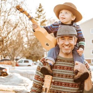 Father carrying son on shoulders