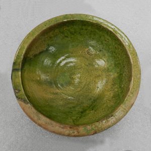 Shallow ceramic bowl with uneven green glaze