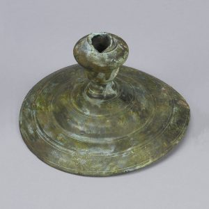 Bronze candlestick with a patina and a round base