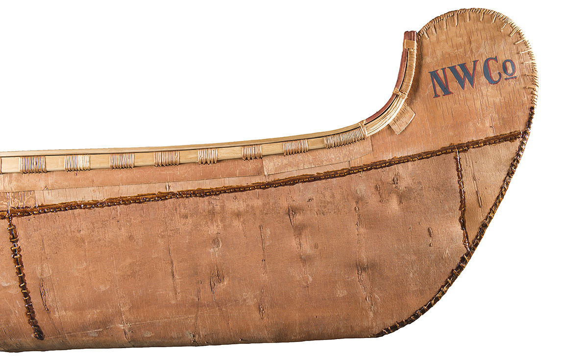 Bow of birchbark canoe with the letters “NWCo”.