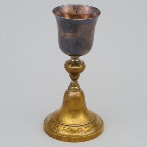 Golden chalice with an inscription on the base.