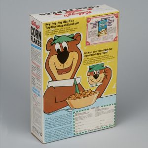 Back of a cereal box featuring a brown bear holding a mug and bowl of cereal, with text in English and French