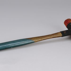 Wooden mallet with green paint on bottom half and a pink rubber head