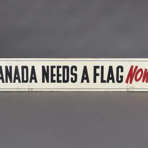 Sign with white background and black lettering that says “Canada needs a flag now!”