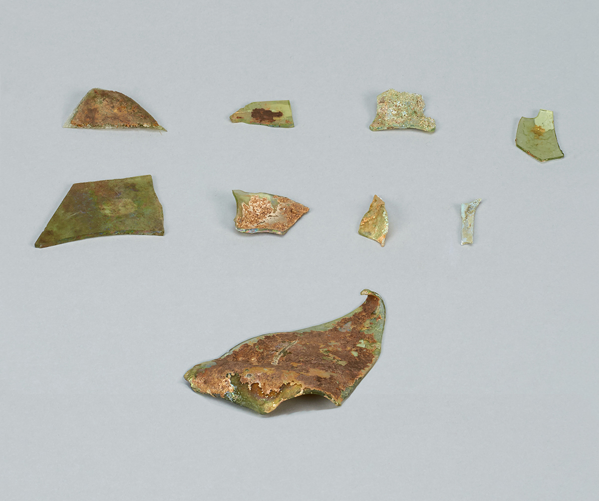 A group of green and brown pieces of pottery showcased at the Canadian Museum of History in Ottawa.