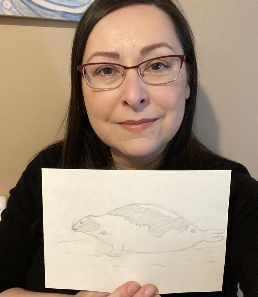 A woman and a drawing of a seal
