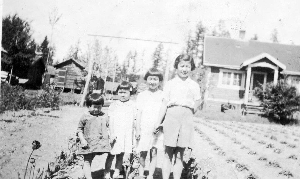 Four sisters standing in front of home
