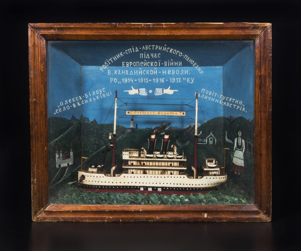 A shadow Box with wood frame containing a model ship.