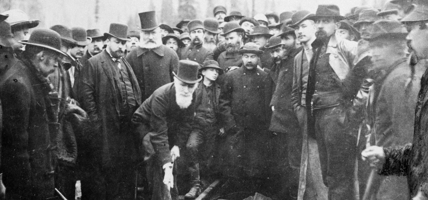 A group of men in hats standing around a body at the Canadian Museum of History in Ottawa.
