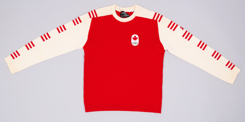 A mostly red sweater with a small Olympic crest on the breast. The arms are white with short red horizontal stripes.
