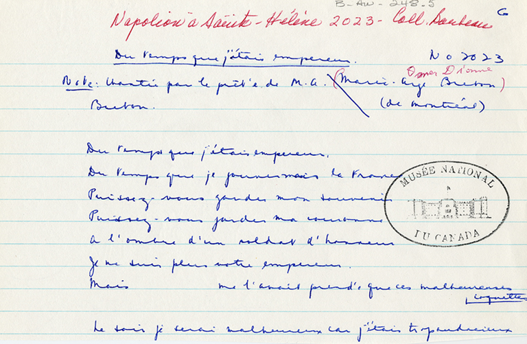A piece of paper covered with handwriting in blue and red, and a stamp reading “MUSEE NATIONAL DU CANADA.”