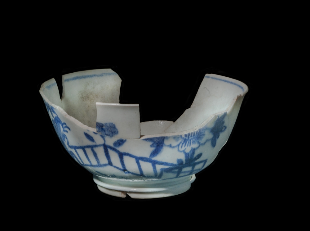 Image of a broken antique blue and white china teacup